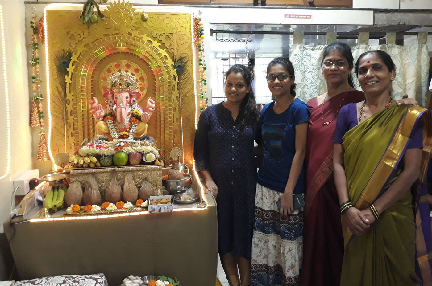 What a beautiful Ganesha idol. Radiant with energy. Staff  take darshan at a beneficiary's home
