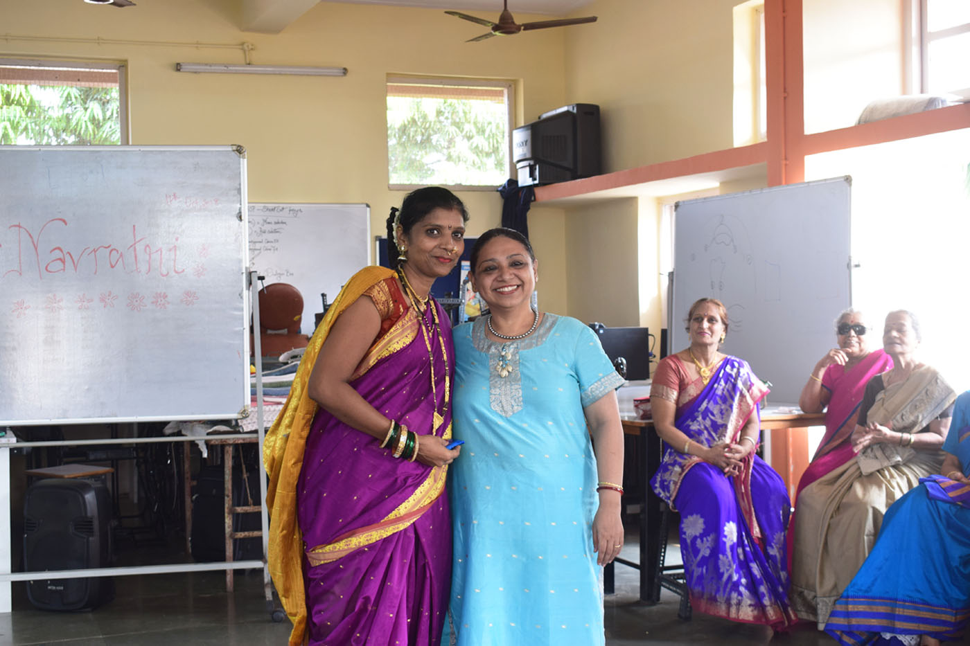 A beneficiary being awarded a prize by one of the teachers