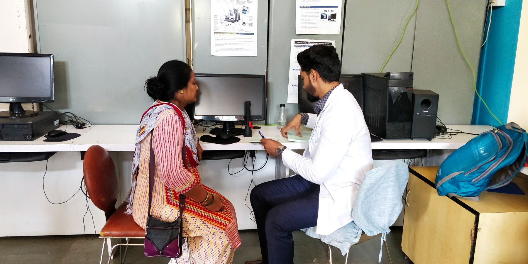 A doctor explaining the nymber to the beneficiary after the eye test exam