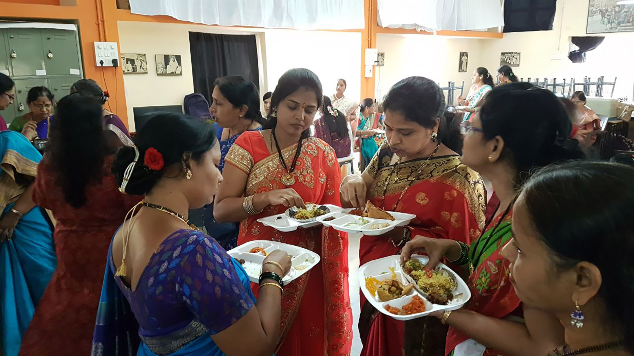 Women enjoying lunch after the haldikumkum celebration
