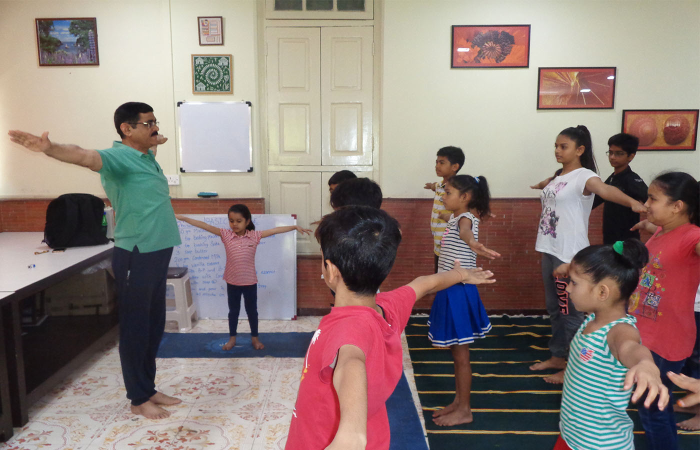 Children are doing aasana during Yoga session