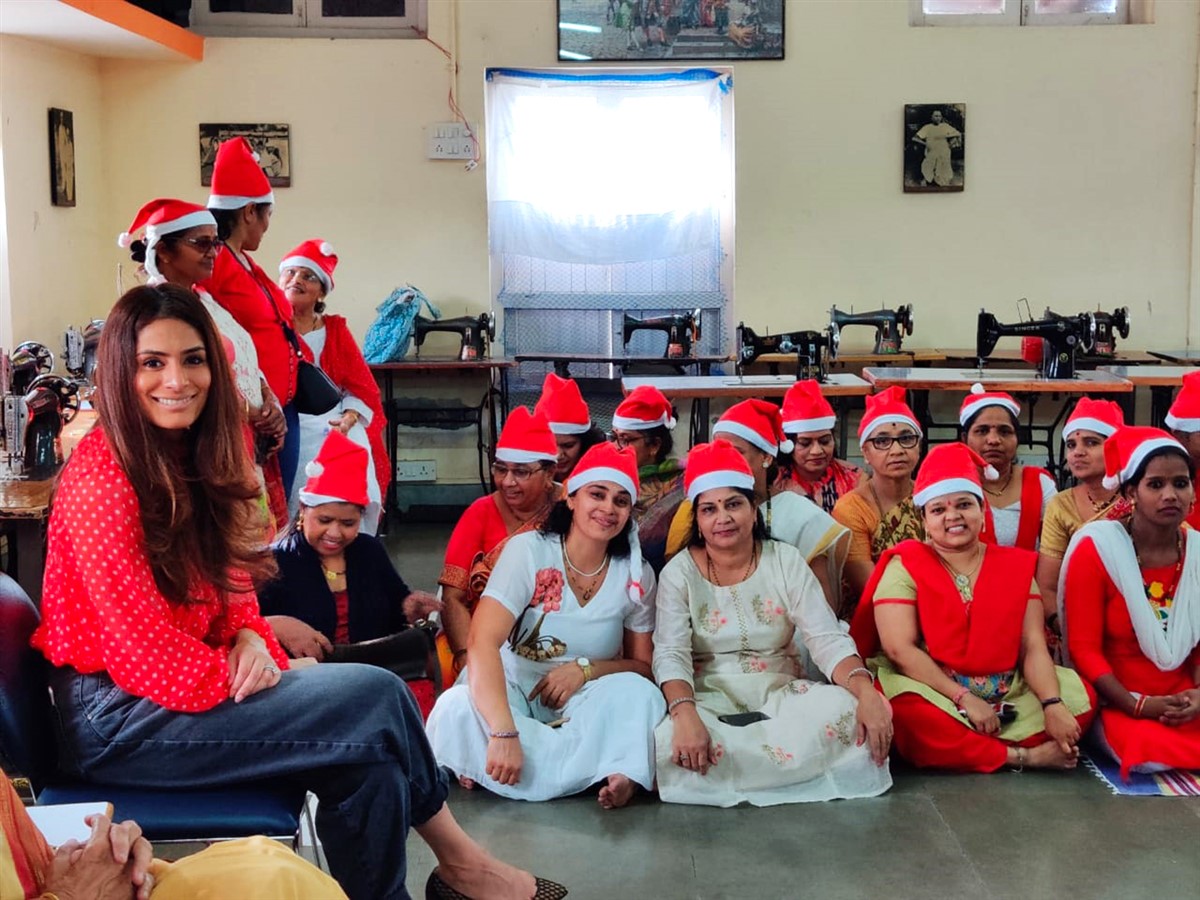 Following the Christmas theme , Ms. Sheetal Bajaj at the Christmas party with the beneficiaries looking on