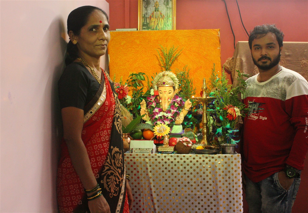 Staff standing next to a Ganesha idol. See how serene and calm he looks.
