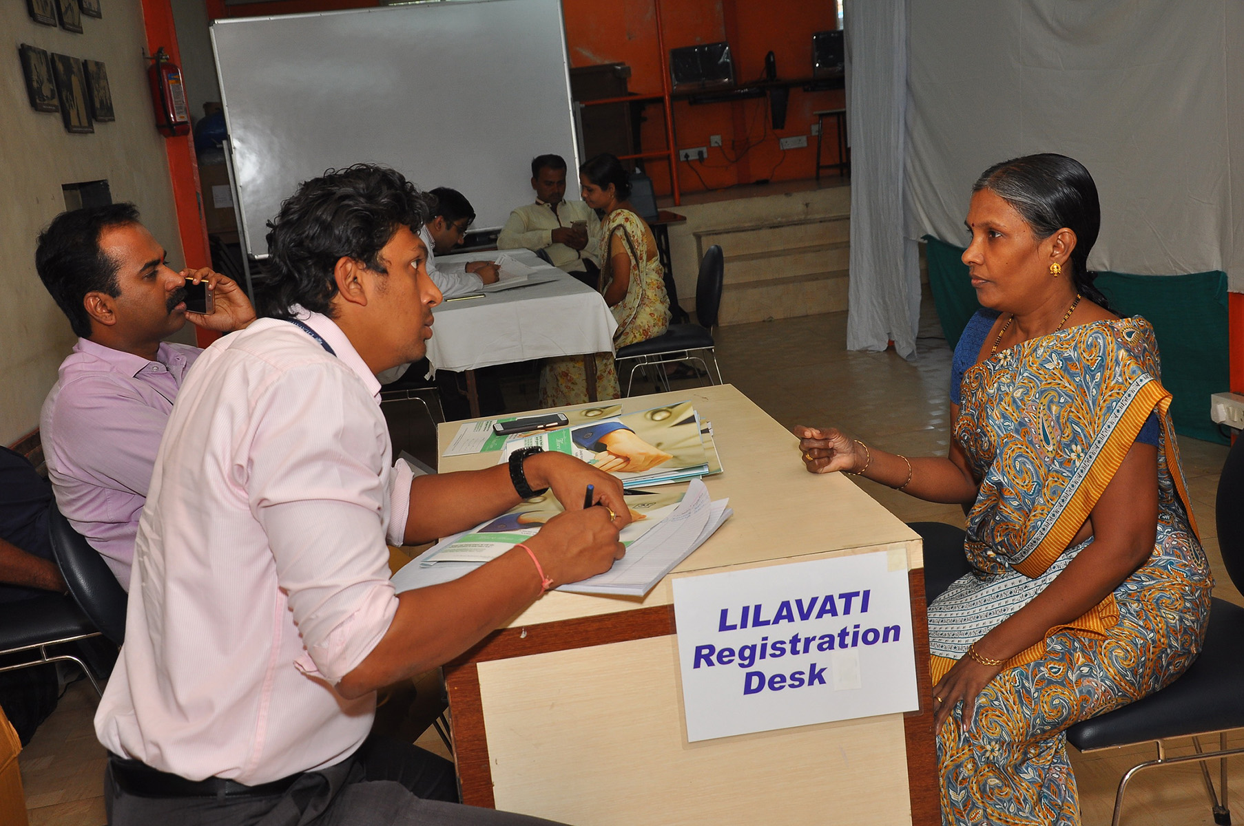 Lilavati Hospital & Research Centre representative noting the registration details of the beneficiaries.
