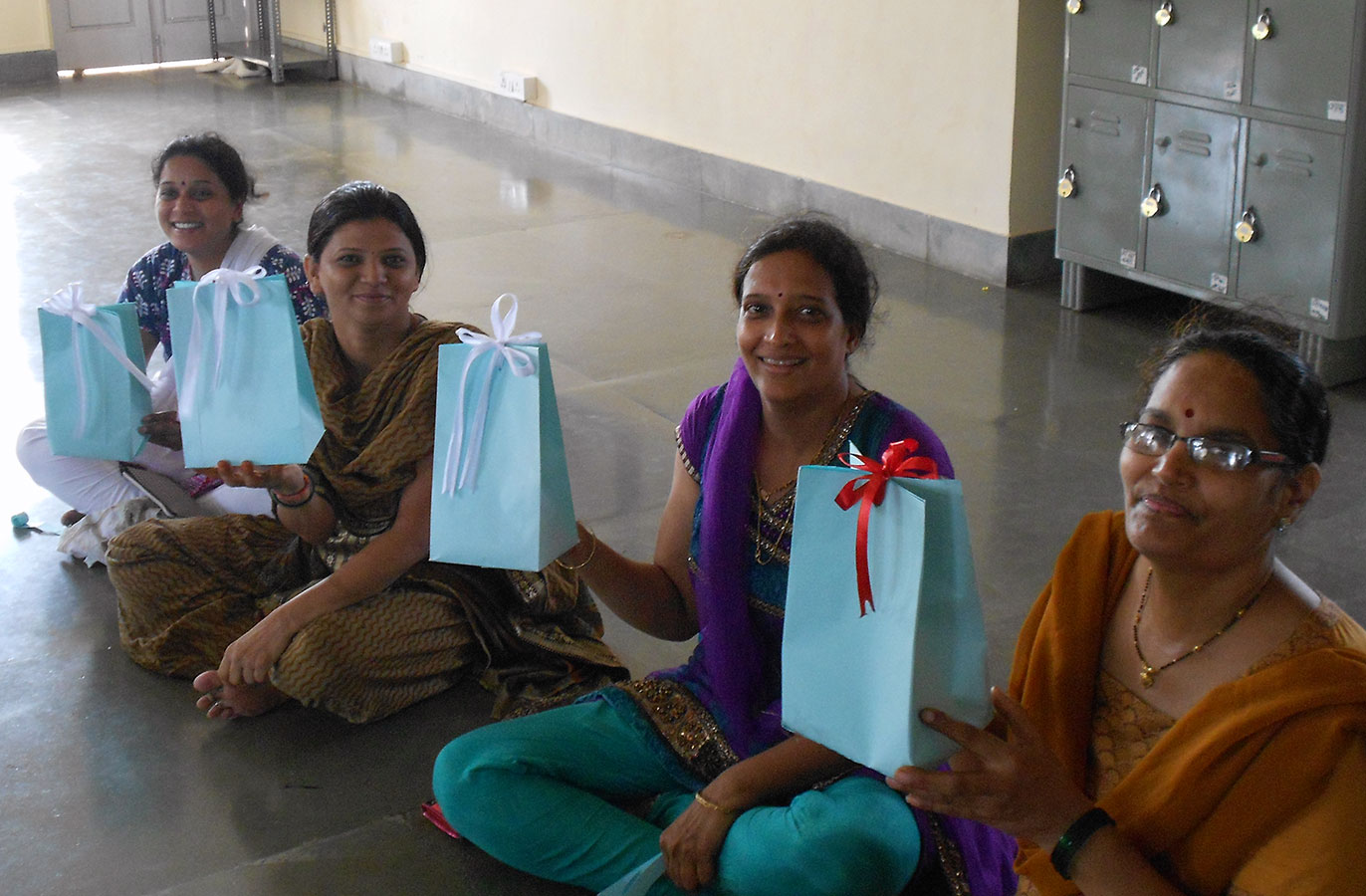 Paper bags with colourful ribbons made by the beneficiaries