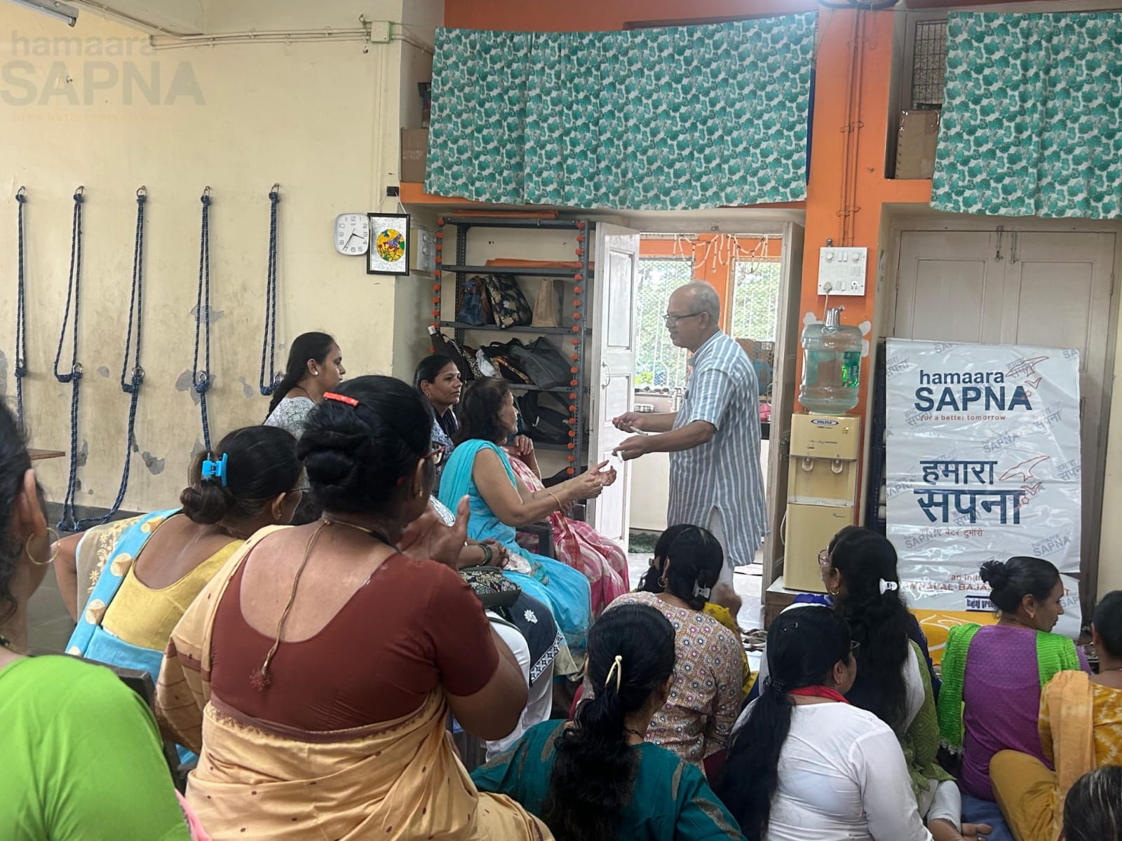 Mr. Madhav Sahasrabudhe gives the real feel of the thread splined on the Charkha to a beneficiary