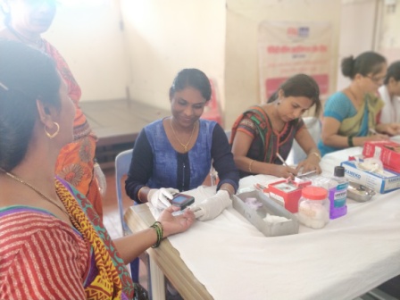 A beneficiary getting her haemoglobin test done by the staff of Kutumb Sudhar Kendra who had come to carry out a haemoglobin test for the staff and beneficiaries of Hamaara Sapna